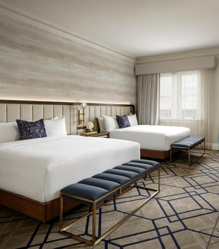 a hotel room with two beds and a window at Fairmont Hotel Macdonald in Edmonton