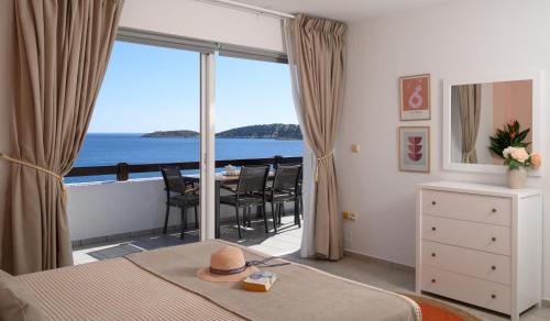 a bedroom with a bed with a view of the ocean at Horizon, Coastal Penthouse in Agios Nikolaos