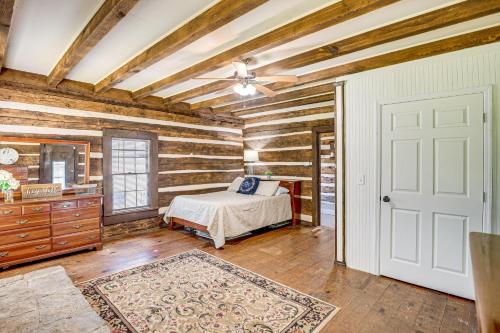 a bedroom with a bed and a wooden wall at 6 Mi to Scottsboro Apt with Furnished Porch in Hollywood