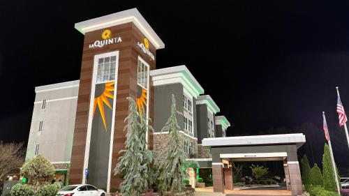 a building with aania sign on it at night at La Quinta by Wyndham Forsyth in Forsyth