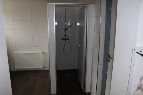 a bathroom with a shower with a shower head at Alpenvereinshaus in Schnepfau