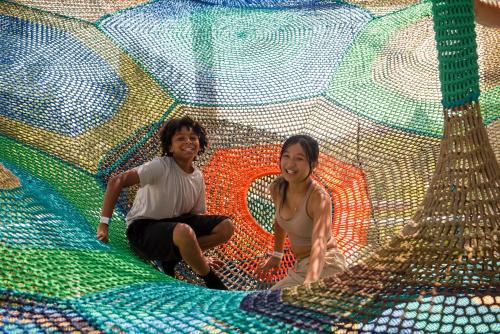 two women are sitting in a large play structure at The Westin Trillium House, Blue Mountain in Blue Mountains