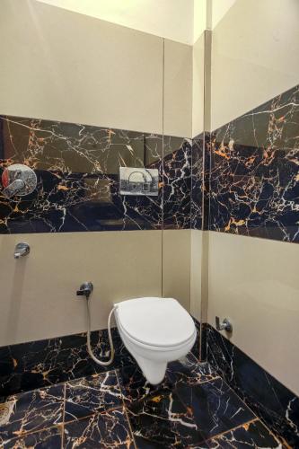 a bathroom with a toilet in a black and gold at Hotel RK Residency Opposite ISBT Sector 43 Chandigarh in Chandīgarh