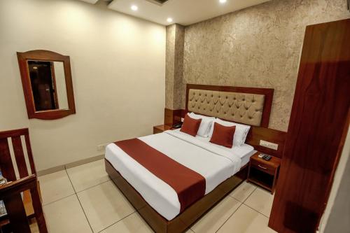 a bedroom with a bed and a mirror at Hotel RK Residency Opposite ISBT Sector 43 Chandigarh in Chandīgarh