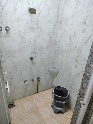a bathroom with a shower with a toilet in it at aaram ac dormitory in Ahmedabad