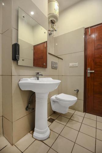 a bathroom with a sink and a toilet at Hotel RK Residency Opposite ISBT Sector 43 Chandigarh in Chandīgarh