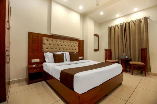 a bedroom with a large bed in a room at Hotel RK Residency Opposite ISBT Sector 43 Chandigarh in Chandīgarh