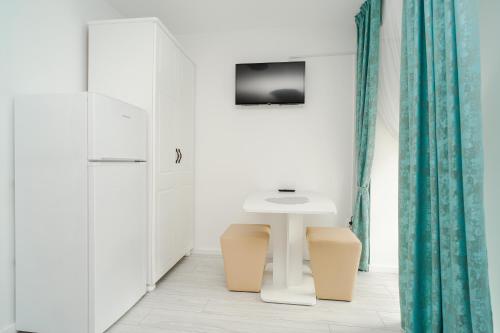 a bathroom with a white table and a sink at Grey Boutique Hotel Palas in Iaşi
