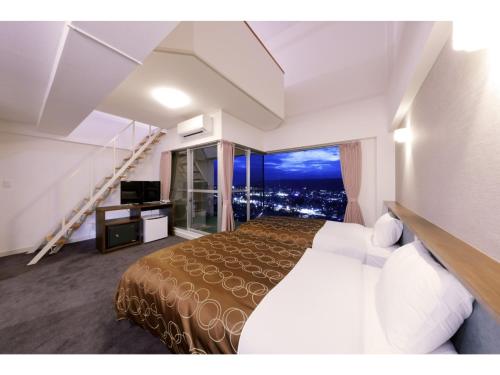a hotel room with a bed and a balcony at Natural Farm City Noen Hotel - Vacation STAY 78838v in Chichibu