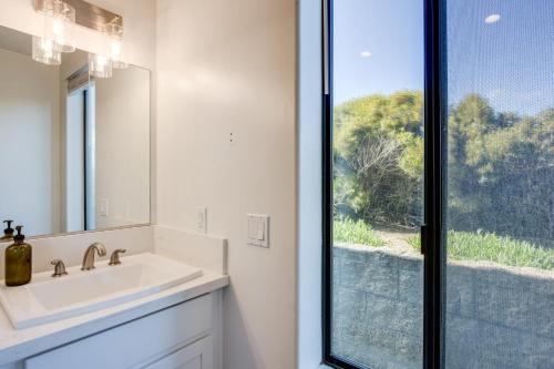 a bathroom with a sink and a mirror and a window at Beachfront 2BR w Deck Views Direct Sand Access Strand Way A in Oceano