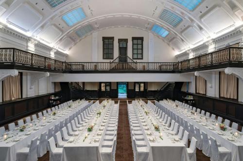 a banquet hall with white tables and white chairs at Bulgari Hotel Shanghai in Shanghai