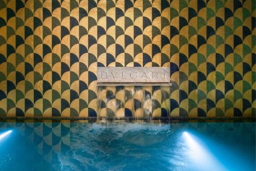 a sign on a wall next to a swimming pool at Bulgari Hotel Shanghai in Shanghai