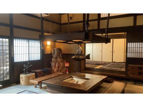 a large room with a table and a mirror at TAKAYANAGI JONNOBI VILLAGE - Vacation STAY 72812v in Kashiwazaki
