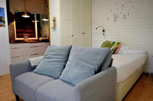 a living room with a couch and a kitchen at Forest Escape near Barcelona in Sant Cugat del Vallès