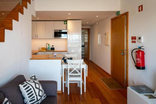 a kitchen and a living room with a table at Casa dos Remedios in Angra do Heroísmo