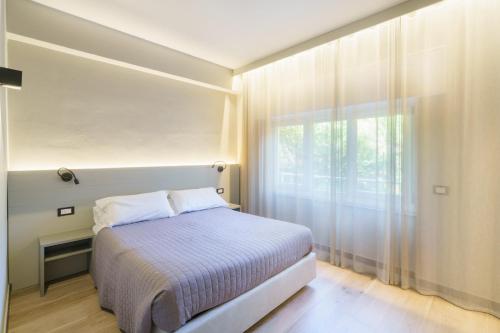 a small bedroom with a bed and a window at The Upper House in Riomaggiore