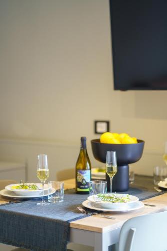 a table with two plates of food and glasses of wine at The Upper House in Riomaggiore