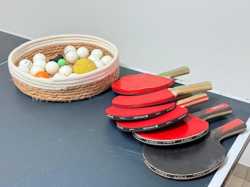 a table with a basket of eggs and a knife at Beautiful house with garden, game, gym, terrace&parking in Strassen