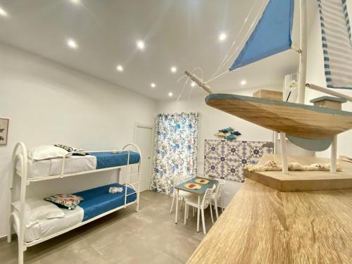 a room with two bunk beds and a table at Vesuvio Rainbow FLY in Naples