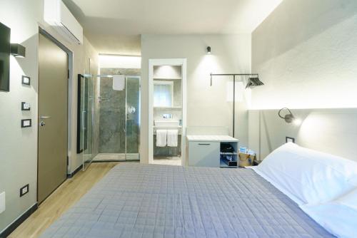 a bedroom with a large bed and a bathroom at The Upper House in Riomaggiore