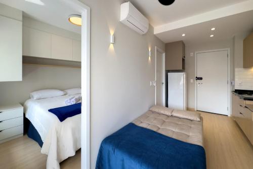 a small bedroom with a bed and a kitchen at Smart Home in Sao Paulo