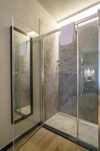 a shower with a glass door in a bathroom at The Upper House in Riomaggiore