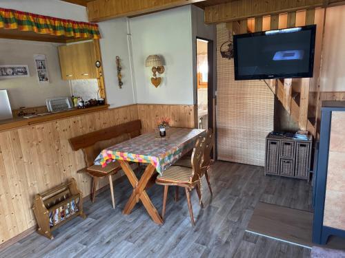 une salle à manger avec une table et des chaises et une télévision dans l'établissement Chata u lesa, à Přeštice