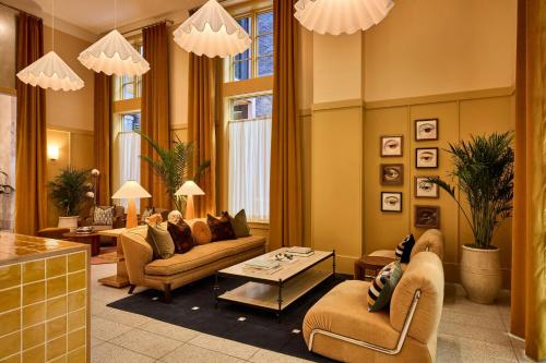 a living room with two couches and a table at The Ann Savannah, Apartments by Marriott Bonvoy in Savannah