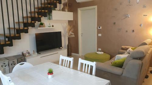 a living room with a table and a couch at Apartment A&D Home Imola in Imola