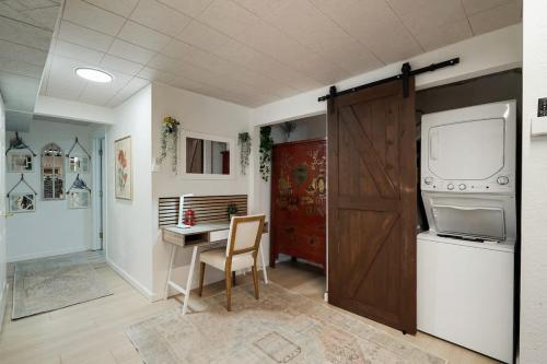 a kitchen with a table and a desk and a refrigerator at Beach Block 2-Bed with Coastal Palm Trees and Yard in Pacifica