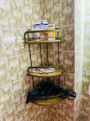 a shelf on a wall with a phone and a hat at Peaceful Seaside Apartments in Vaia