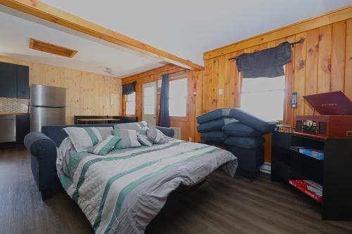 a bedroom with a bed and a chair in it at Private Hot tub new 2 Bedroom Home in Catskills in Elka Park