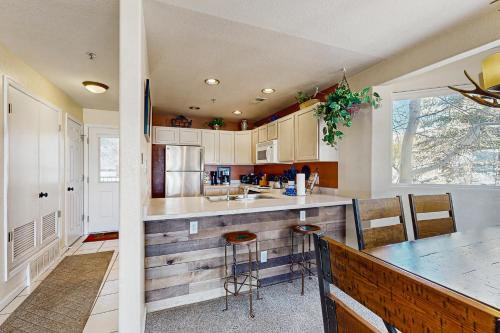 a kitchen with a counter and a table with chairs at Bay Club 107 in Frisco