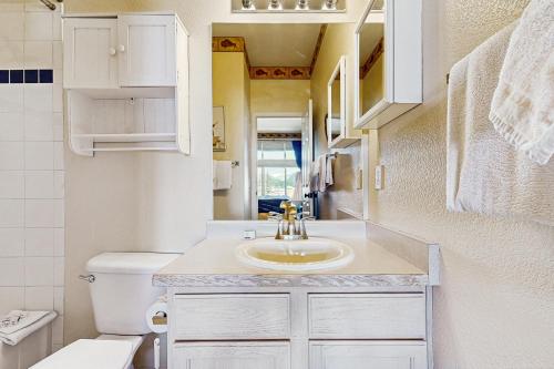a small bathroom with a sink and a toilet at Bay Club 107 in Frisco