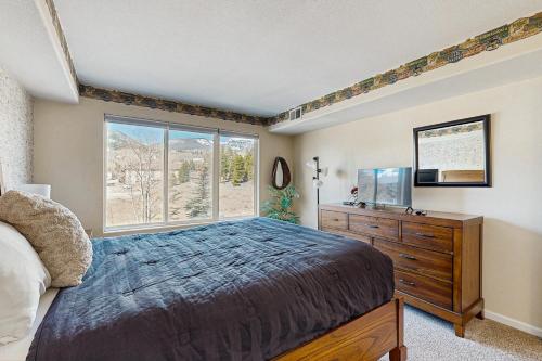 a bedroom with a bed and a window and a dresser at Bay Club 107 in Frisco