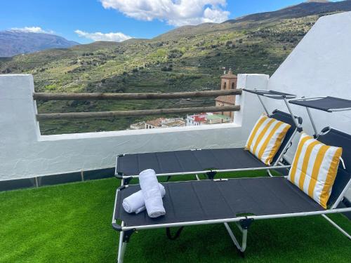 a chair on a balcony with a view of a mountain at El Balcón de Ohanes R&R in Ohanes