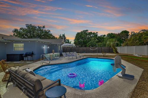 a swimming pool in a yard with a patio at Backyard Oasis w Sand Volleyball Mins to Beach in Seminole