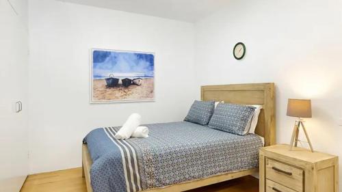 a bedroom with a bed and a picture on the wall at Coasters 2 in Sawtell