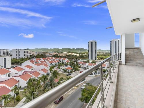 a balcony with a view of a city at Crystal Waters Condo in Lowlands