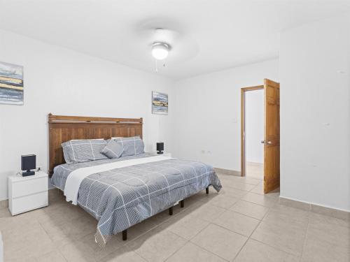 a bedroom with a bed and a television in it at Crystal Waters Condo in Lowlands