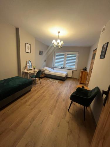 a bedroom with a bed and a couch in a room at Happy 4 in Krosno