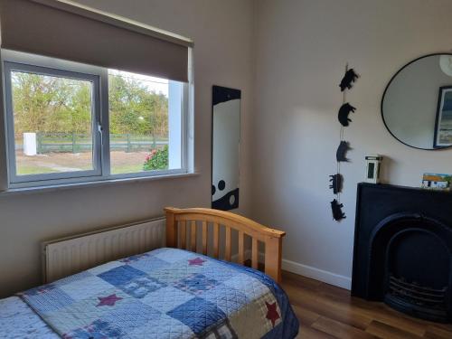 a bedroom with a bed and a window at Lakeside house in Oughterard