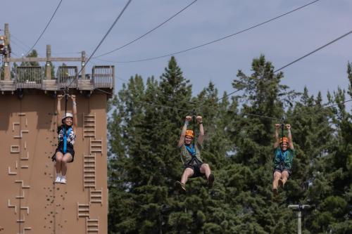 two people riding on the zip line at a resort at The Westin Trillium House, Blue Mountain in Blue Mountains