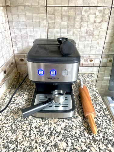 a stove with a pot on top of it on a counter at Comfortable Apartment Bedroom And Spacious Living Room Family and Couple in Sharjah