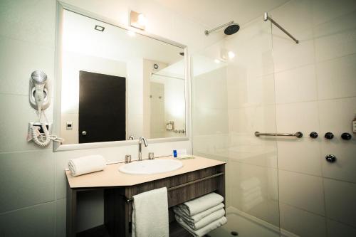 a bathroom with a sink and a shower with a mirror at Unit Santa Rosa in Santa Rosa