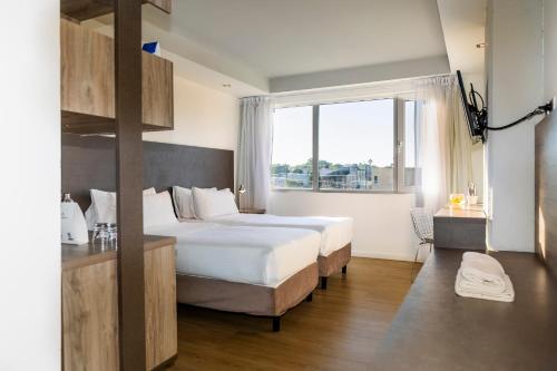 a hotel room with two beds and a window at Unit Santa Rosa in Santa Rosa