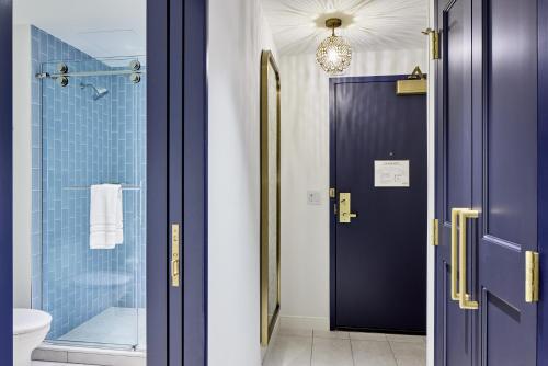 a bathroom with a purple door and a shower at Universal Helios Grand Hotel, a Loews Hotel in Orlando