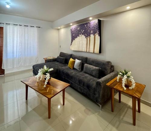 a living room with a couch and two tables at Departamento Mina La Negrita in Hidalgo del Parral
