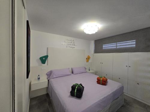 a bedroom with a bed with two bags on it at Yumbo Tinache Luxury Maspalomas in Maspalomas