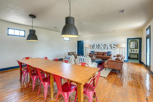 a dining room with a wooden table and red chairs at Southwest Escape in Fort Davis Walk to Dining! in Fort Davis